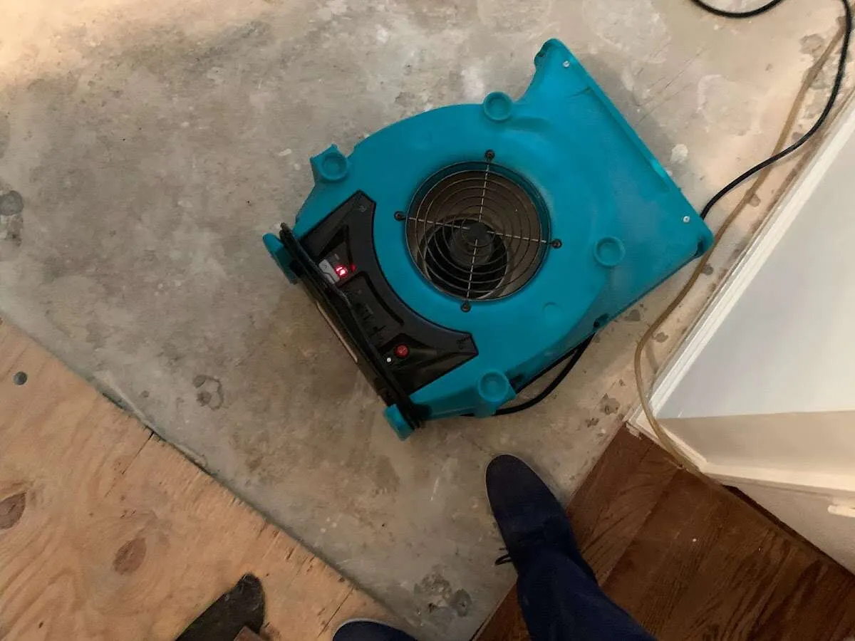 Air mover drying subfloor during Commercial Water Damage Restoration in Port LaBelle